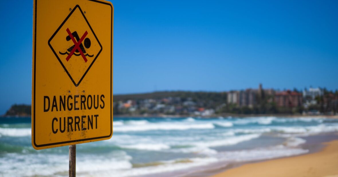 warning sign posted at California beach closed due to aggressive sharks