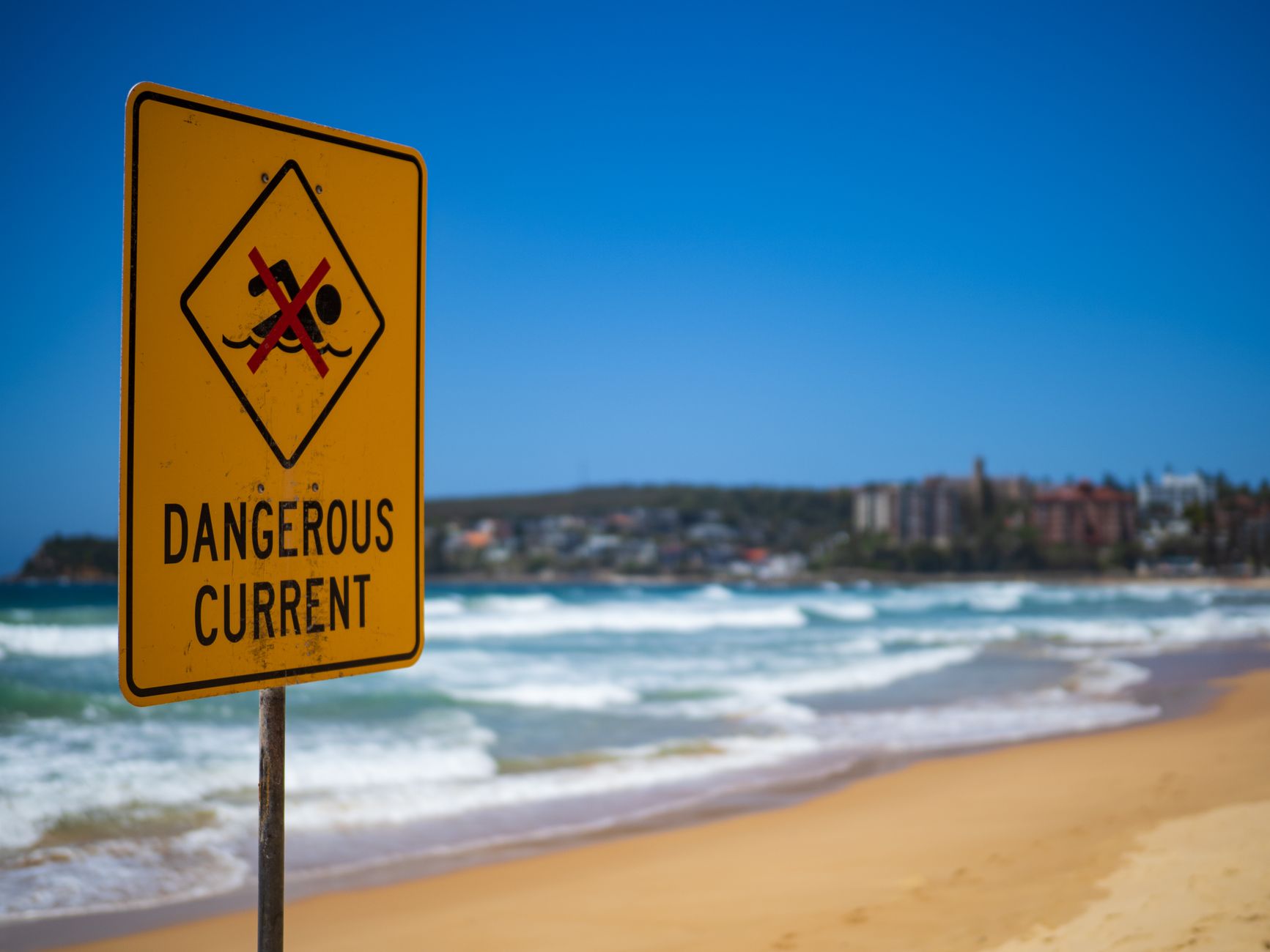 warning sign posted at California beach closed due to aggressive sharks