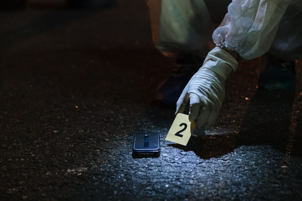 detectives investigating a fatal shooting scene at an apartment complex in east Kansas City