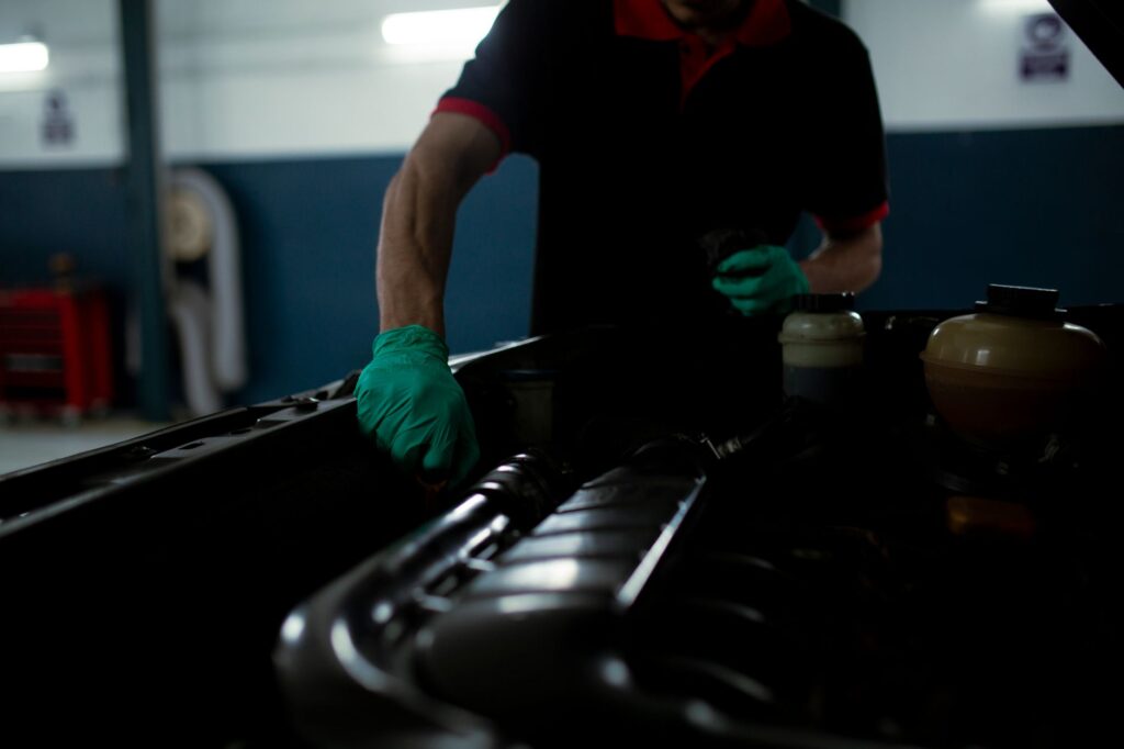 volunteer mechanic performing free oil change for single mother