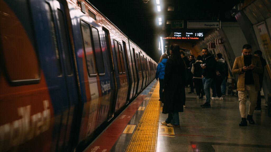 female commuter practicing subway safety awareness on NYC train