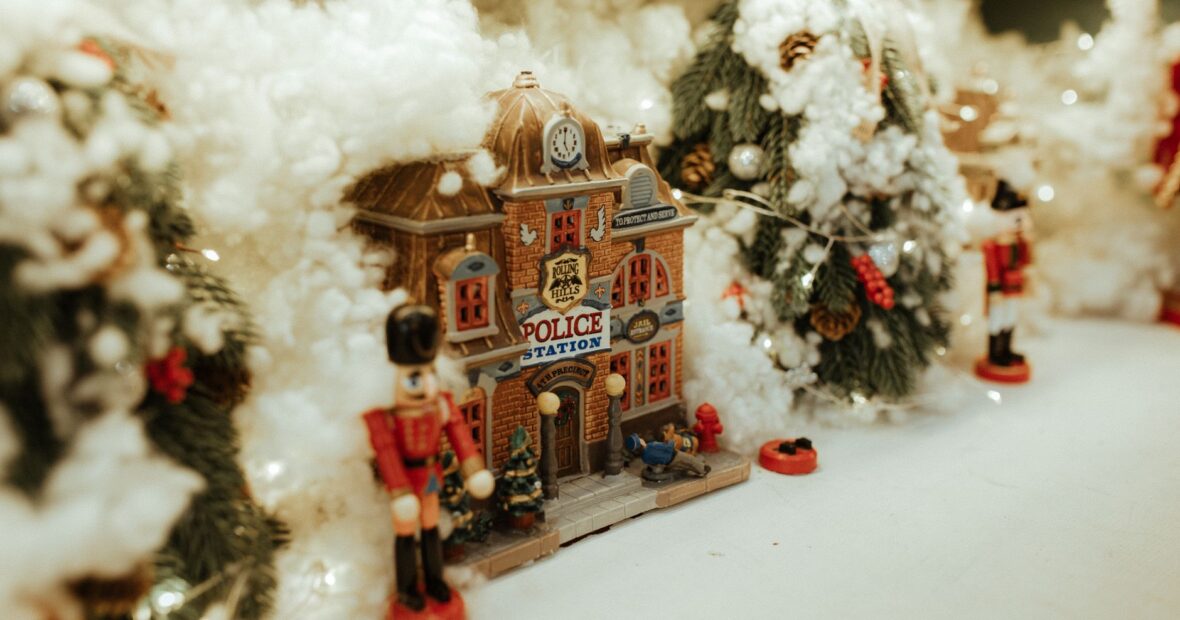 citizens gathered around a festive Christmas tree village display