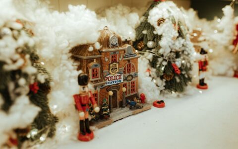 citizens gathered around a festive Christmas tree village display