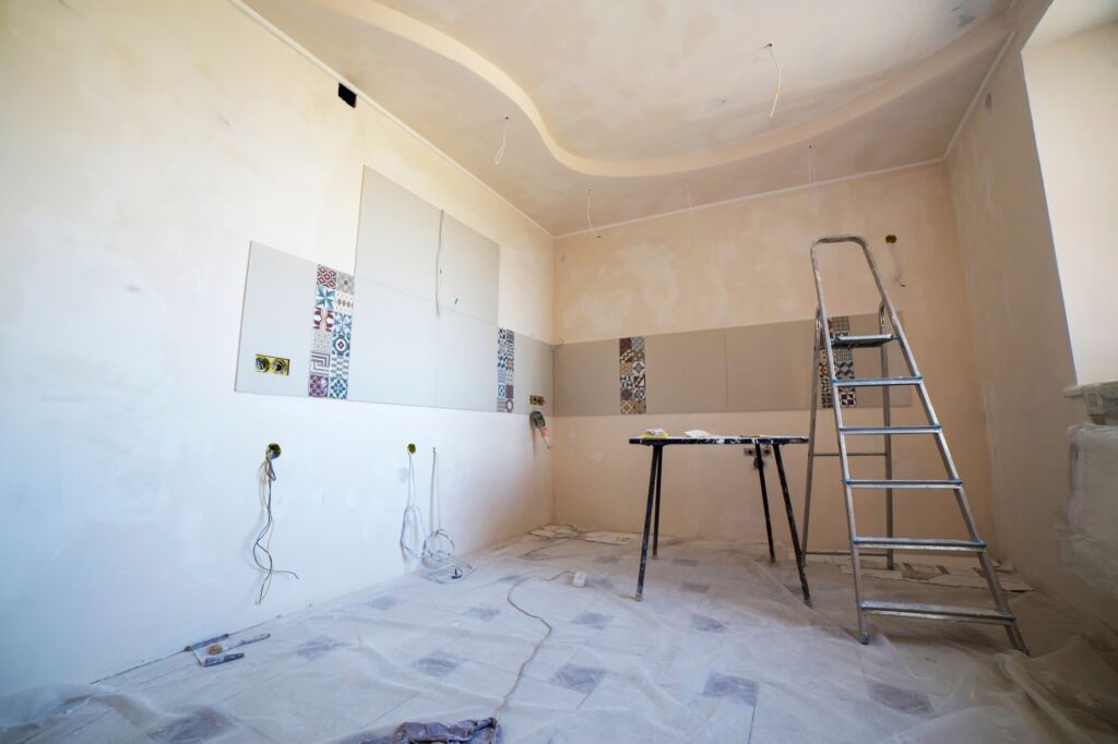 homeowner removing old popcorn ceiling during renovation