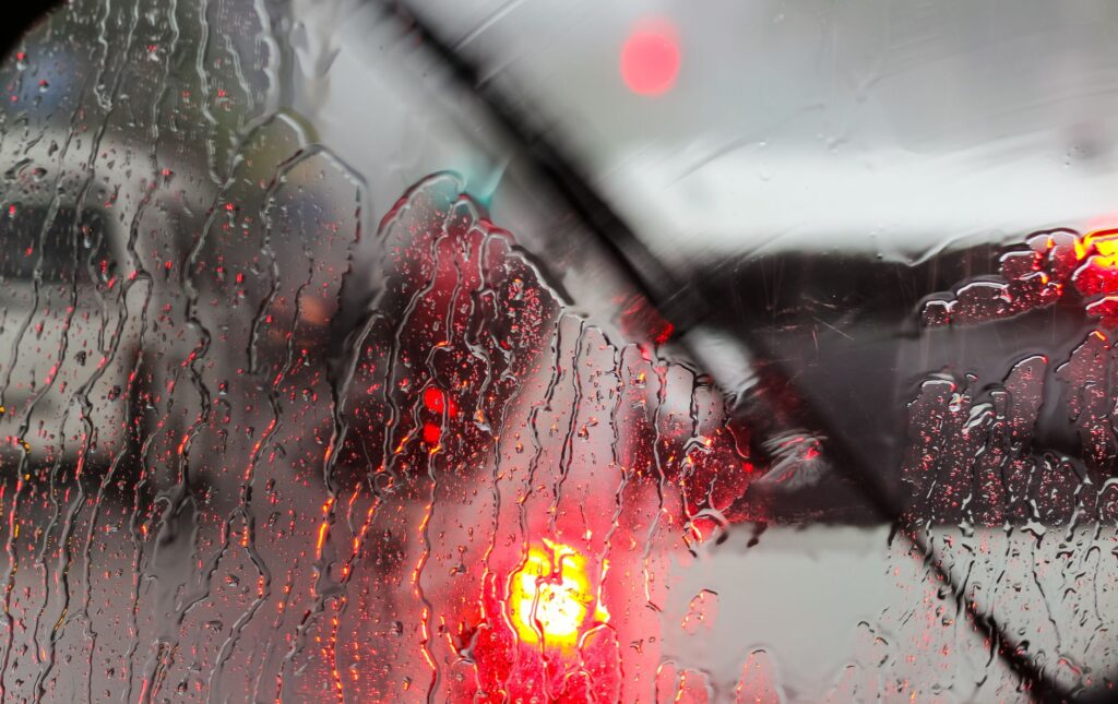 driver navigating wet road following wet weather traffic advice