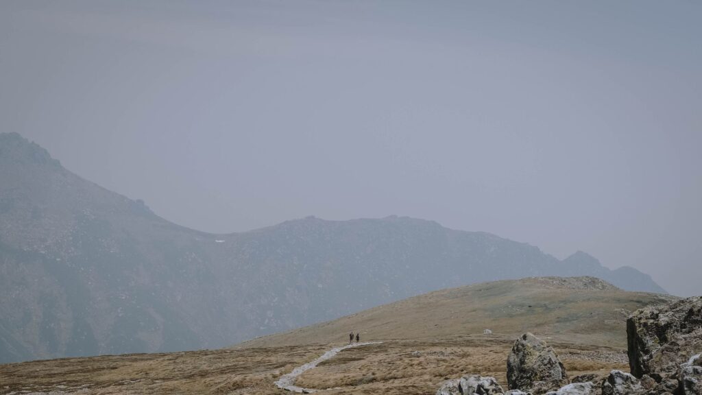 hikers ascending a rocky trail toward Maine's highest point, Mount Katahdin