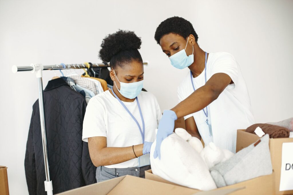 volunteers helping New York Cares donate coats and gifts to Bronx students