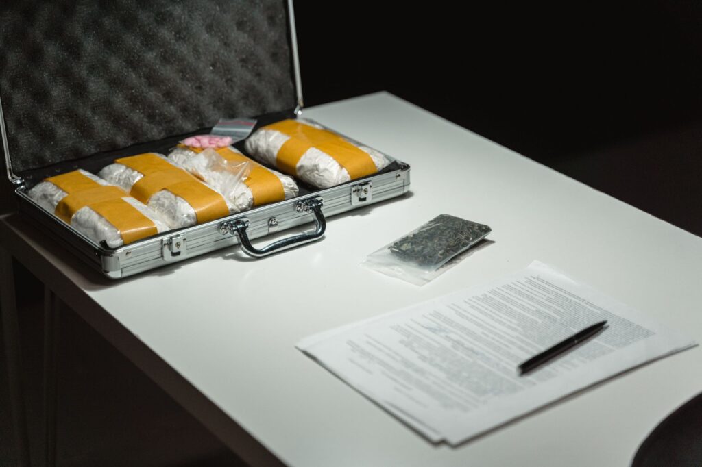 detectives examining evidence during a Maryland narcotics and weapons investigation