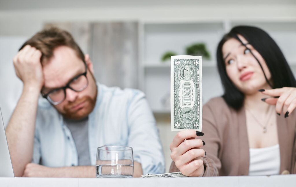 couple discussing finances at a kitchen table symbolizing marital stress