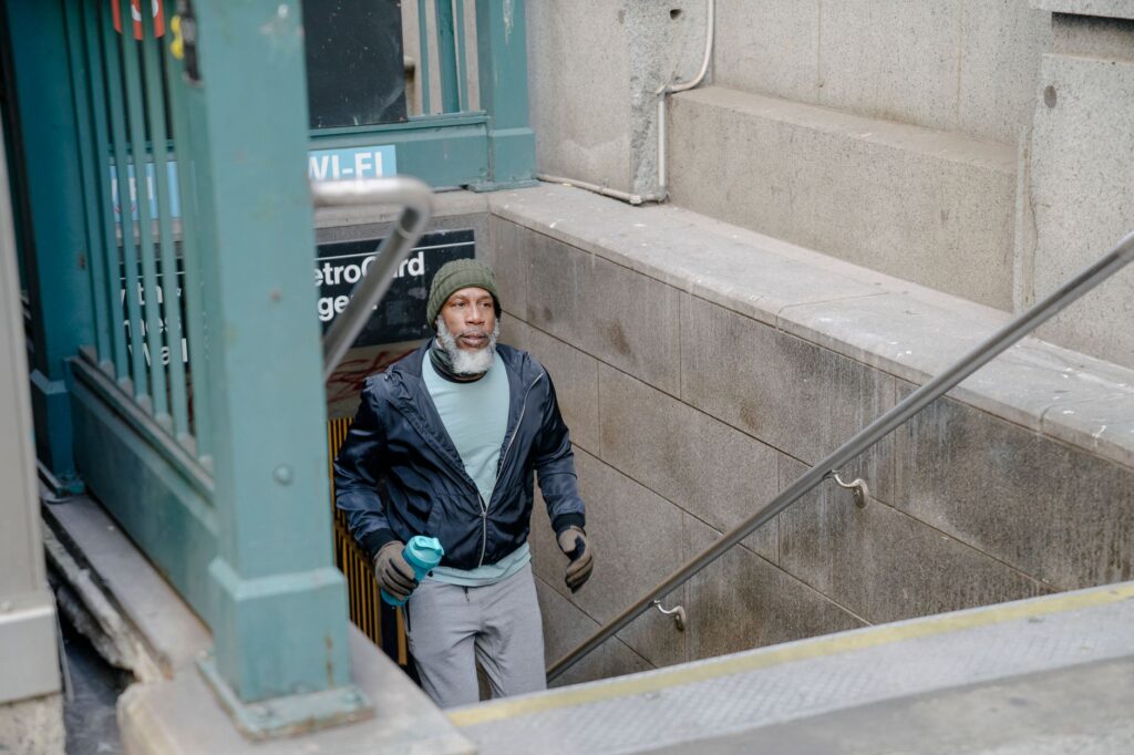 elderly man waiting at subway platform illustrating vulnerability of older transit riders