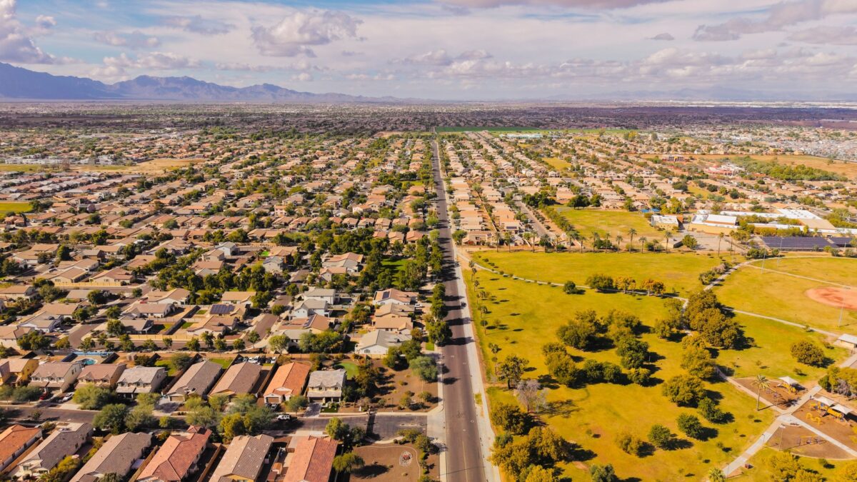 Aerial view of a suburban Arizona neighborhood with desert mountains in the distance
