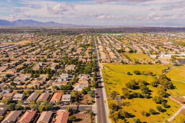 Aerial view of a suburban Arizona neighborhood with desert mountains in the distance