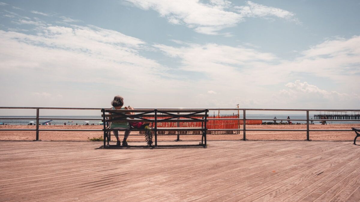 Bench on a beachfront boardwalk with ocean views