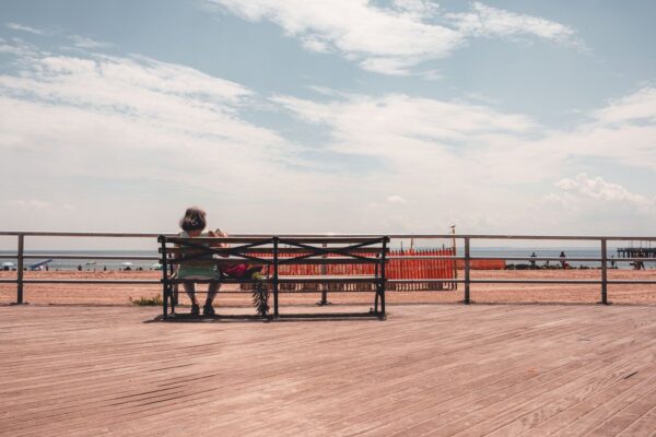 Bench on a beachfront boardwalk with ocean views