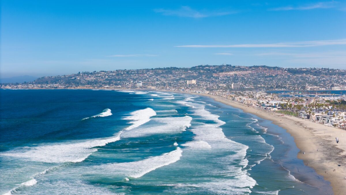 Aerial view of San Diego's coastline with waves breaking along sandy beaches