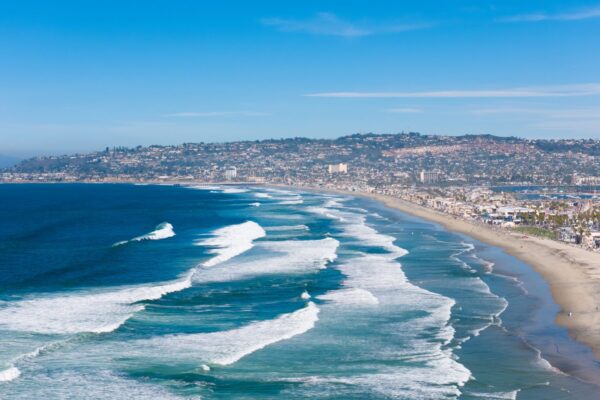 Aerial view of San Diego's coastline with waves breaking along sandy beaches