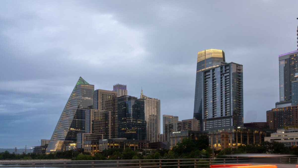 Downtown Austin skyline at dusk with Sixth Street lights glowing