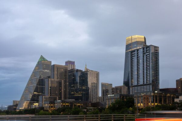 Downtown Austin skyline at dusk with Sixth Street lights glowing