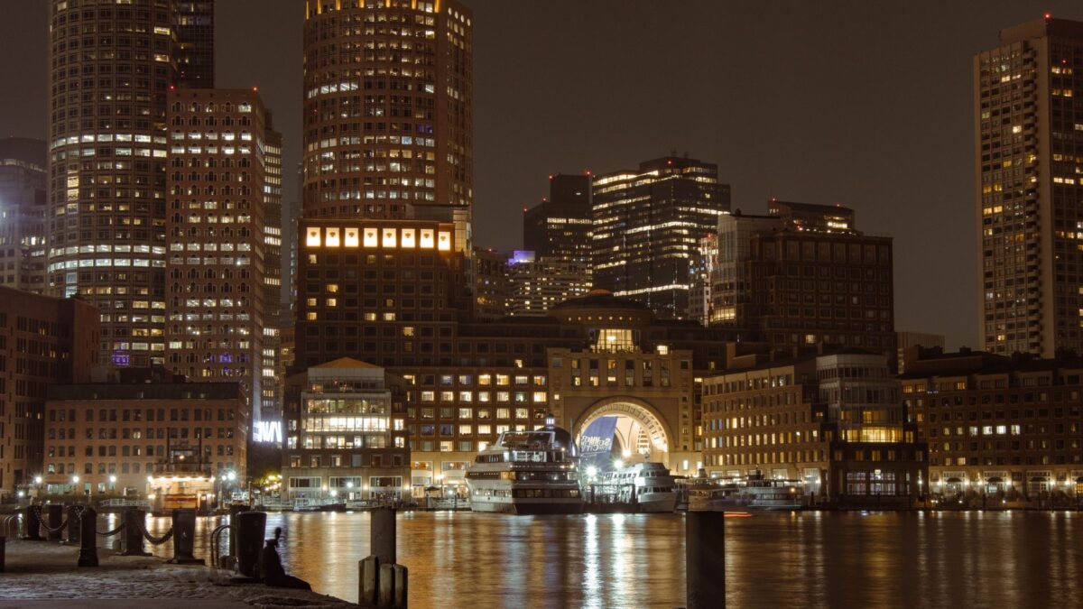 Boston's illuminated skyline over the harbor at night