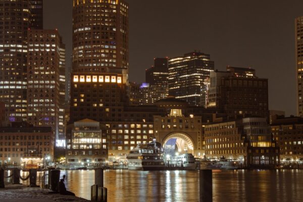 Boston's illuminated skyline over the harbor at night