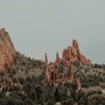 Pikes Peak rising over Colorado Springs, Colorado, with red rock formations in the foreground