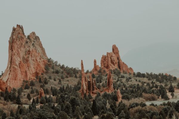 Pikes Peak rising over Colorado Springs, Colorado, with red rock formations in the foreground