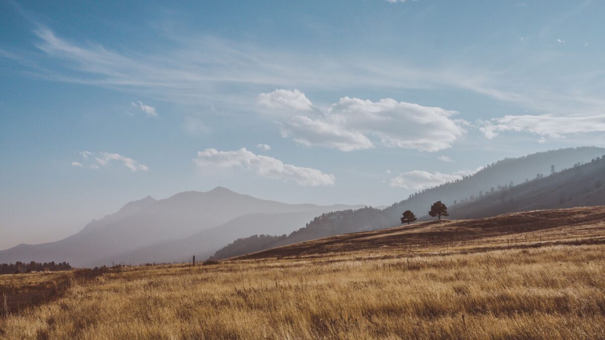 Colorado town with mountains under a hot summer sky