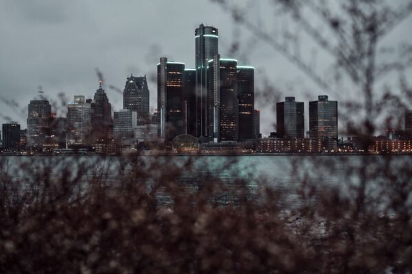 Detroit skyline at dusk with downtown towers along the Detroit River