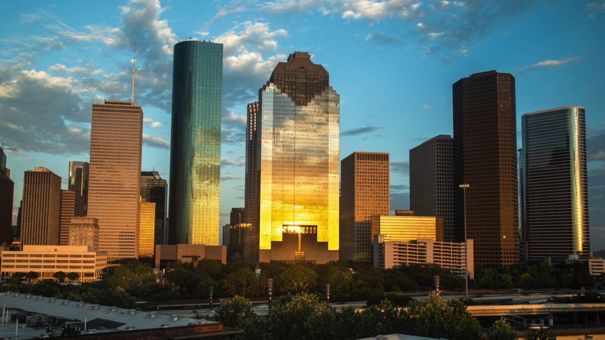 Houston Texas skyline at dusk with the downtown skyscrapers glowing against the evening sky