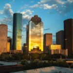 Houston Texas skyline at dusk with the downtown skyscrapers glowing against the evening sky