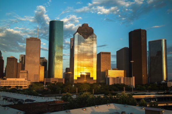 Houston Texas skyline at dusk with the downtown skyscrapers glowing against the evening sky