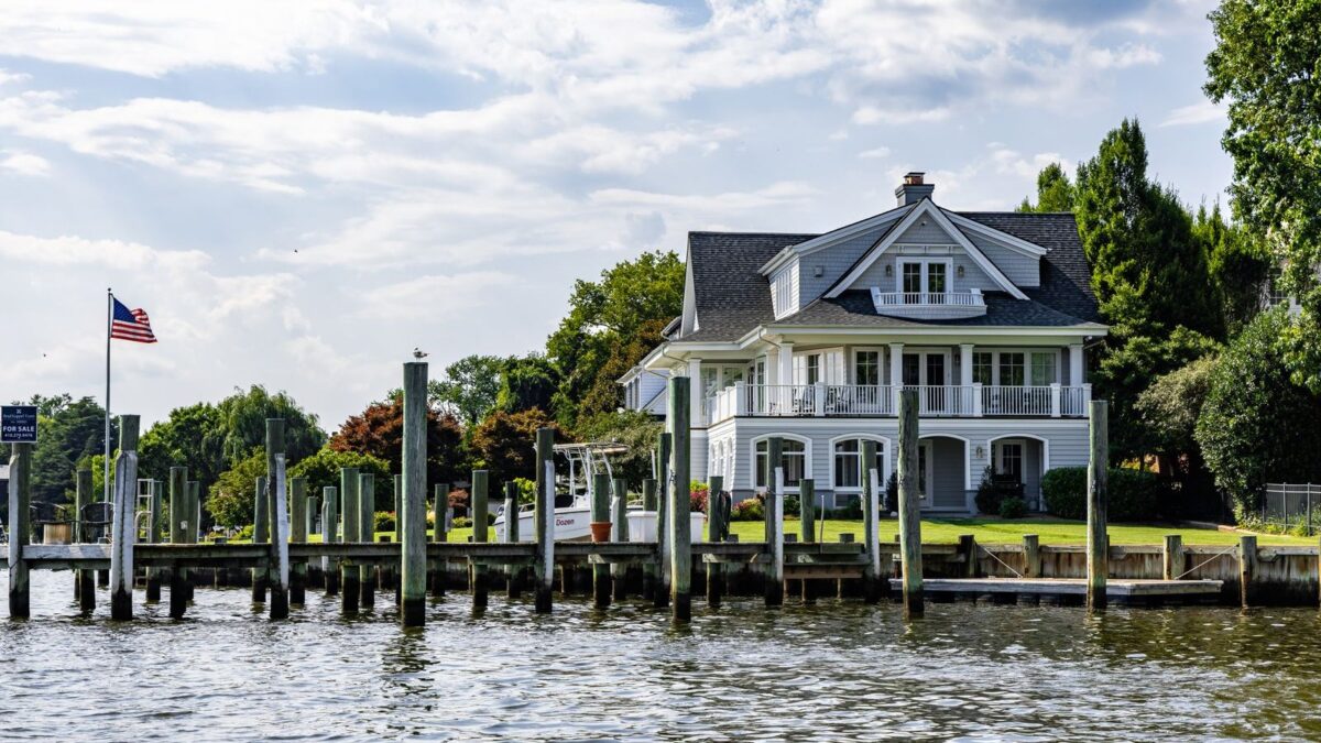 Waterfront home with a dock on a sunny summer day
