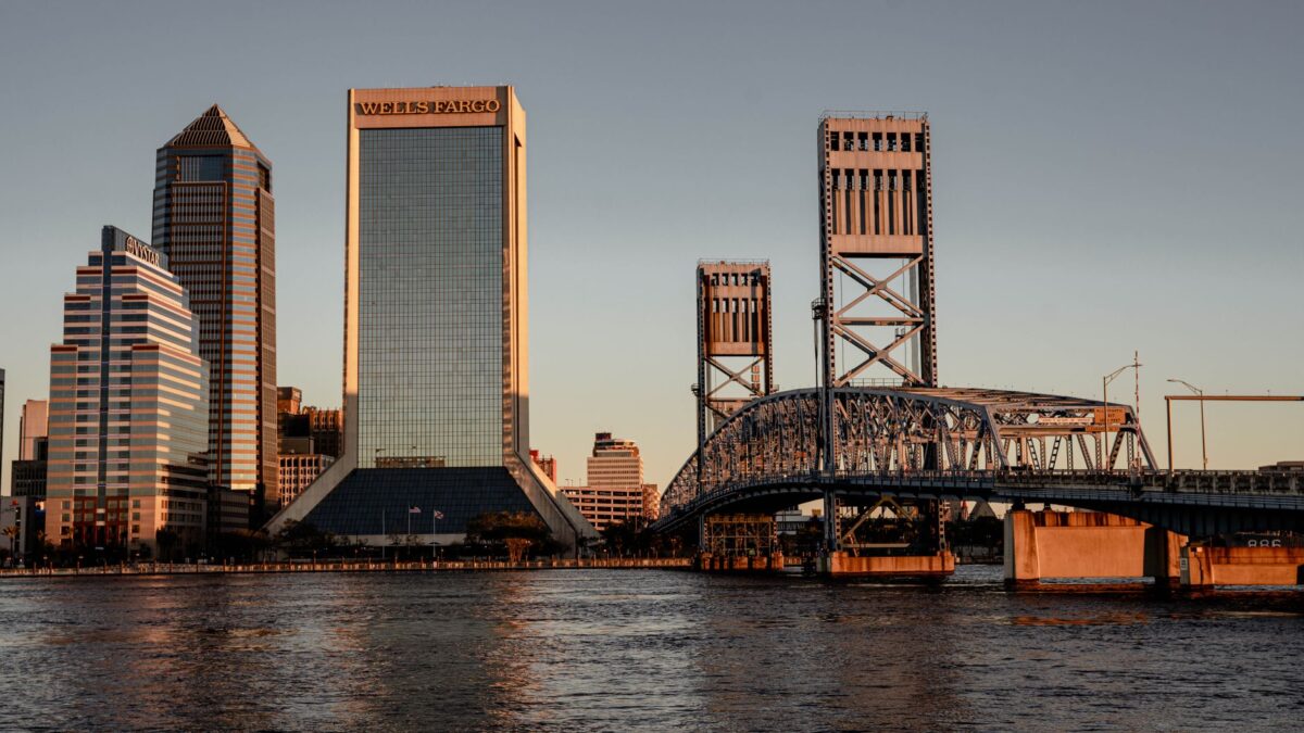 Downtown Jacksonville, Florida skyline with bridges over the St. Johns River at sunset