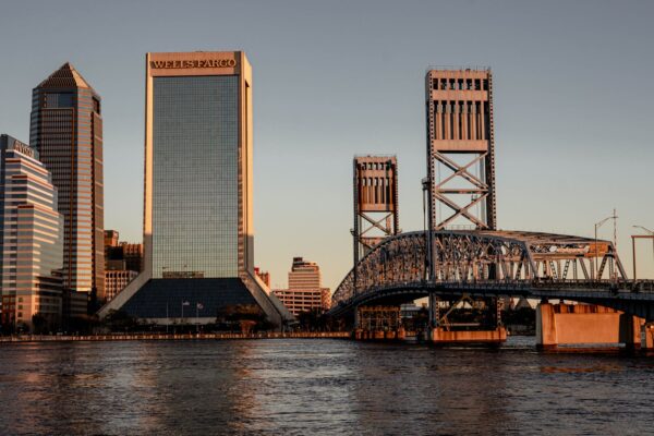 Downtown Jacksonville, Florida skyline with bridges over the St. Johns River at sunset