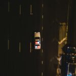 Police cruiser with flashing lights on a dark highway at night