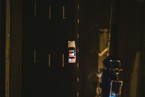 Police cruiser with flashing lights on a dark highway at night
