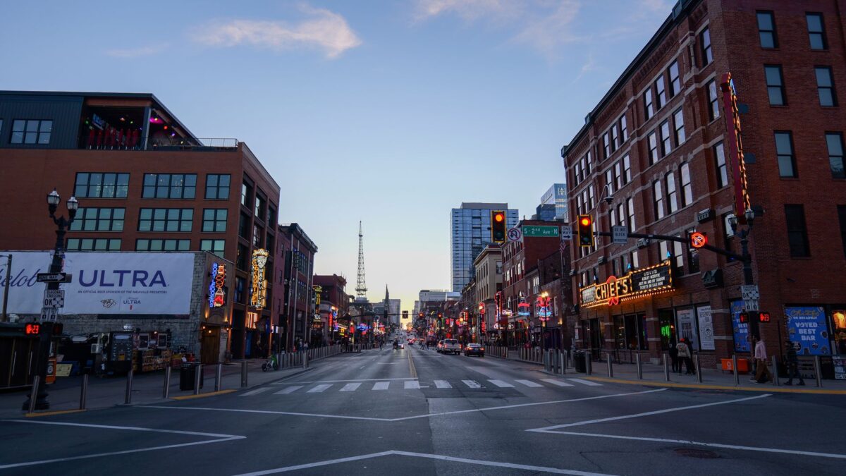 Broadway street in downtown Nashville with neon signs and honky-tonks at dusk