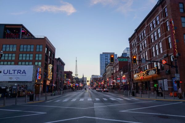 Broadway street in downtown Nashville with neon signs and honky-tonks at dusk