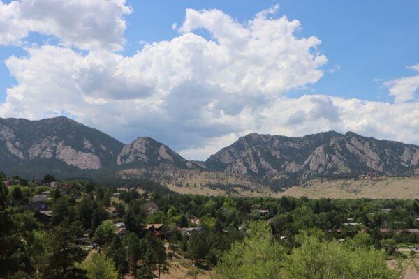 Snow-dusted Flatirons rising above Boulder, Colorado under a blue sky