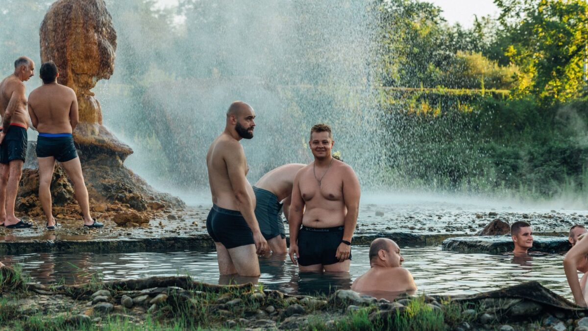 Visitors soaking in a natural hot spring pool
