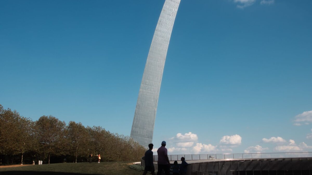 Tourists silhouetted at the Gateway Arch in St. Louis, Missouri