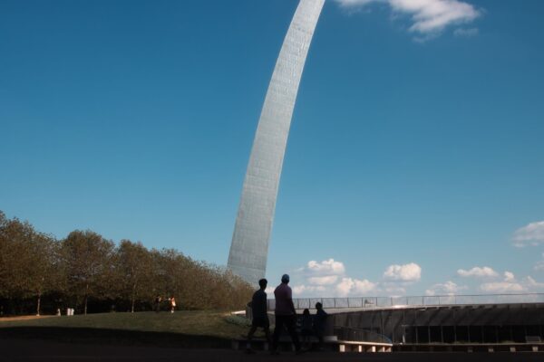 Tourists silhouetted at the Gateway Arch in St. Louis, Missouri
