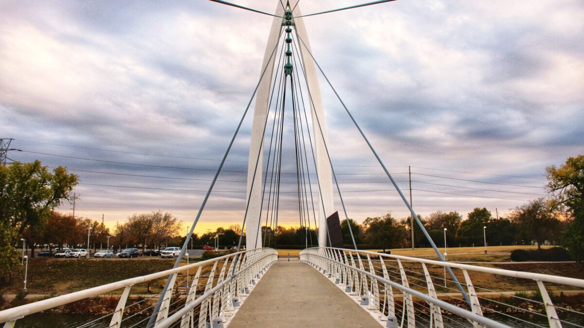 Pedestrian cable-stayed bridge over the Arkansas River in Wichita, Kansas at sunset
