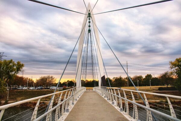 Pedestrian cable-stayed bridge over the Arkansas River in Wichita, Kansas at sunset